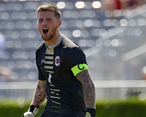 Olly Marshall celebrating wearing the captain's armband for College of Charleston