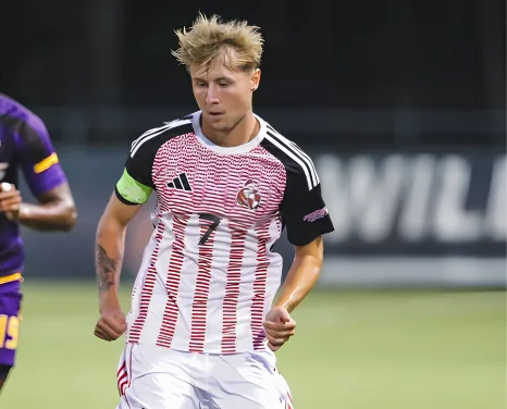 Rico Duggan on the ball wearing the captain's armband